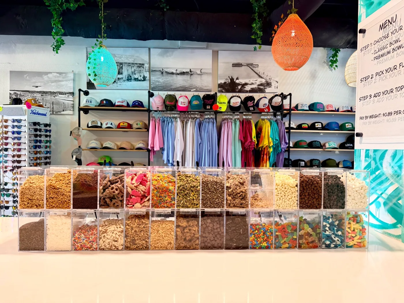 The full toppings bar at AMI FroYo with bins of candy, fruit, granola and sauces