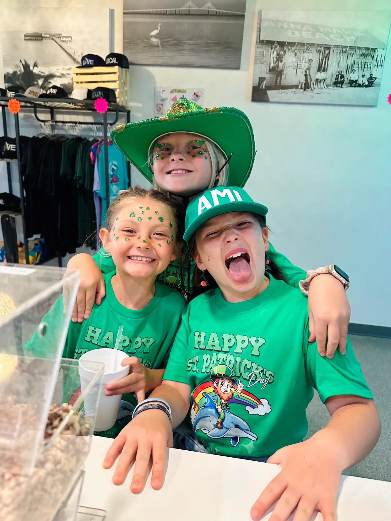 Three kids in St. Patrick's Day gear at the AMI FroYo counter