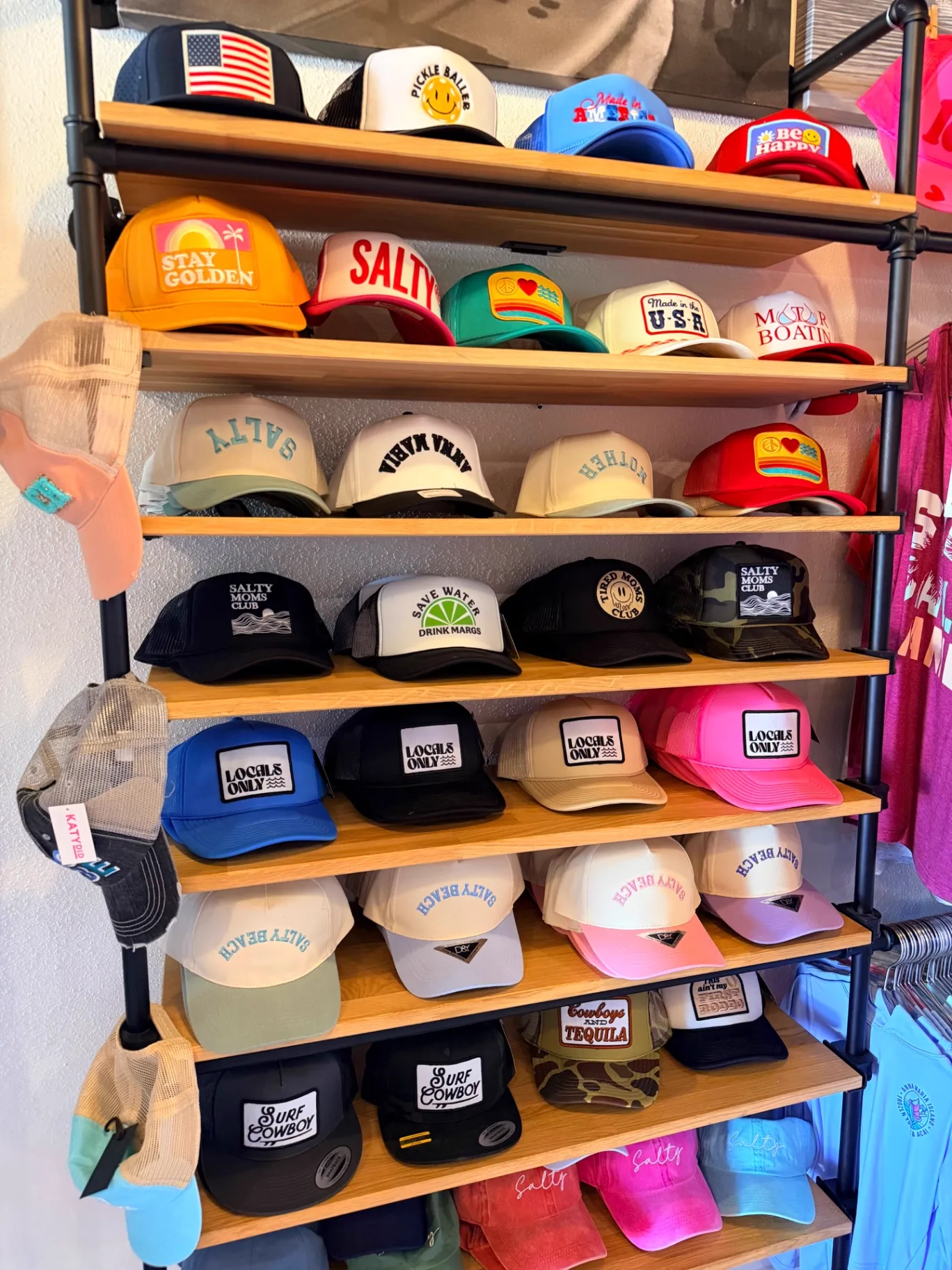 Shelves of trucker hats at the AMI FroYo hat wall