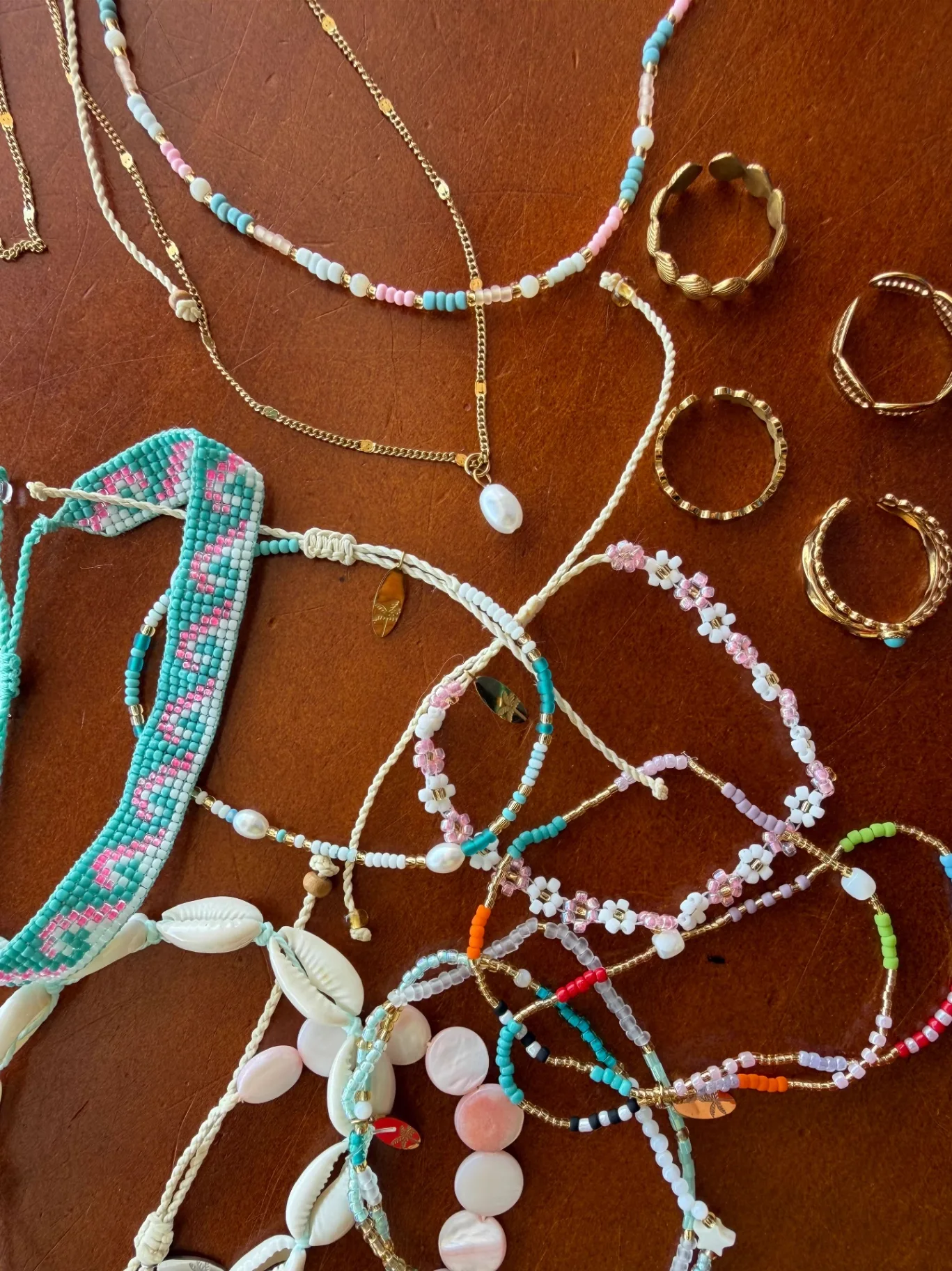 Beaded bracelets, shell necklaces and gold rings laid out at the AMI FroYo boutique
